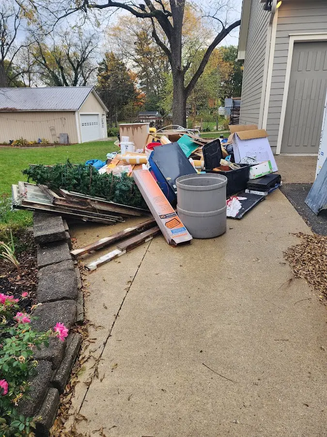Dumpster being loaded with debris for Estate Cleanout Dumpster Rental in Parsippany-Troy Hills